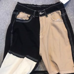 This is a color block tan black and white jean pant.